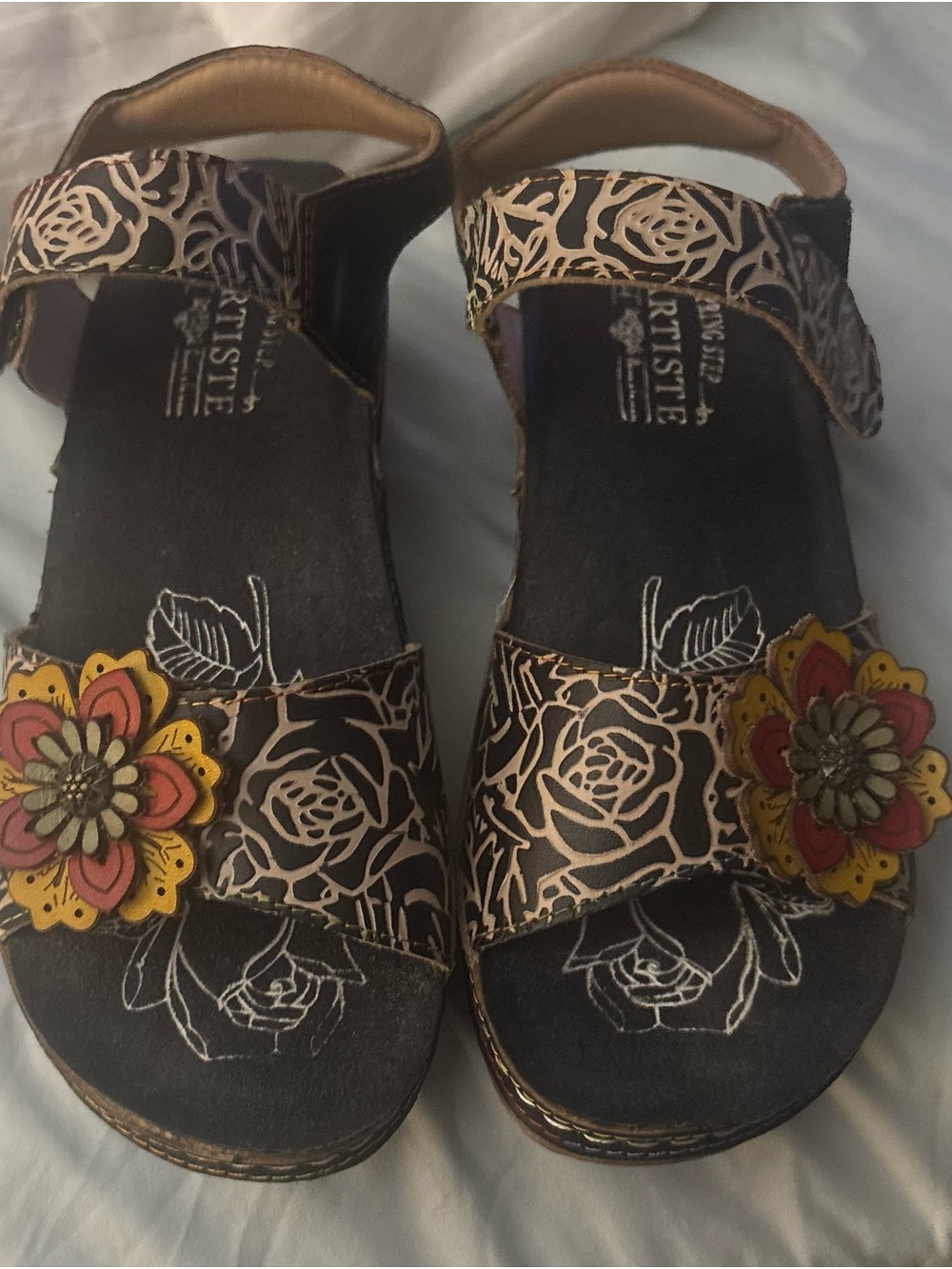 L’Artiste Black Floral Leather Sandals with Red and Yellow Flower Accents